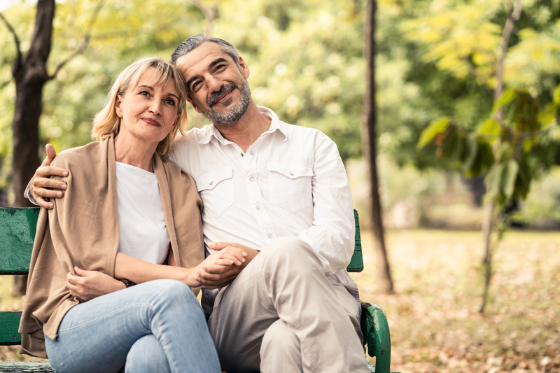 Couple sitting on a bench in Toronto enjoying the benefits of BHRT